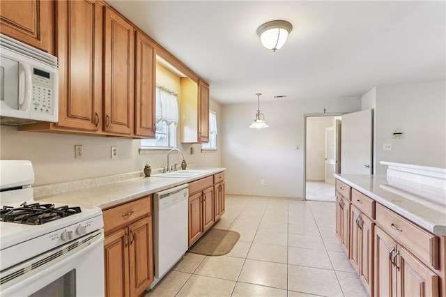 142 E Randall Ct, Gretna, LA 70053 - kitchen with white appliances, light countertops, brown cabinetry, and light tile patterned flooring