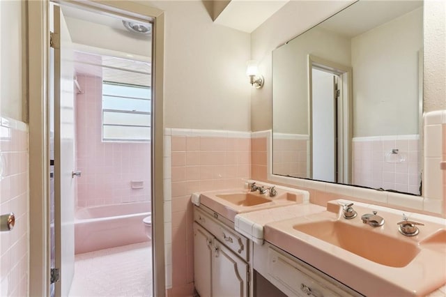 142 E Randall Ct, Gretna, LA 70053 - full bath with tile walls, double vanity, a wainscoted wall, and shower / washtub combination