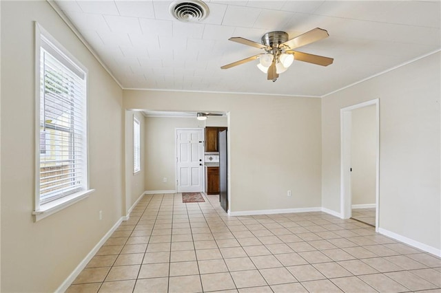53941 Angela St, Arabi, LA 70032 - spare room with ceiling fan, ornamental molding, and light tile patterned floors