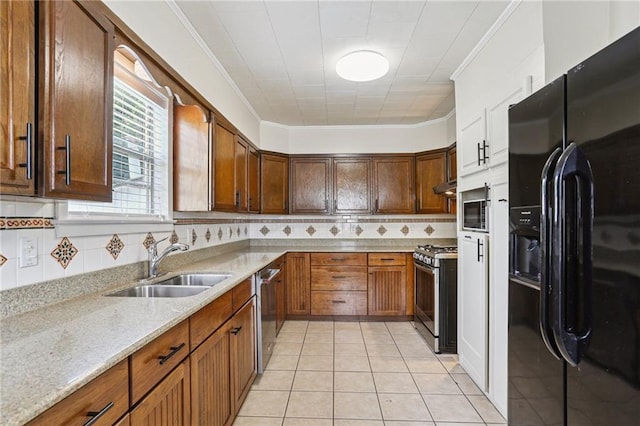 53941 Angela St, Arabi, LA 70032 - kitchen featuring stainless steel appliances, ornamental molding, backsplash, light stone counters, and light tile patterned flooring