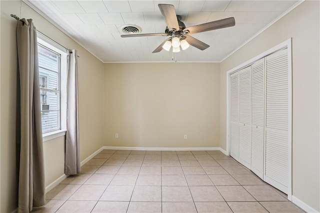 53941 Angela St, Arabi, LA 70032 - unfurnished bedroom featuring ornamental molding, a closet, ceiling fan, and light tile patterned floors