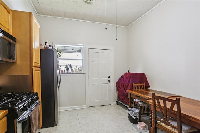 53941 Angela St, Arabi, LA 70032 - kitchen with stainless steel appliances, light tile patterned flooring, ornamental molding, and brown cabinets