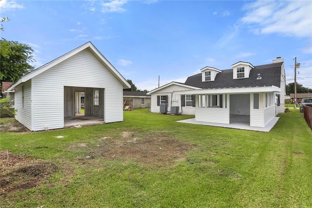 313 Post Dr, Luling, LA 70070 - back of property featuring a patio, a chimney, a lawn, and a shingled roof