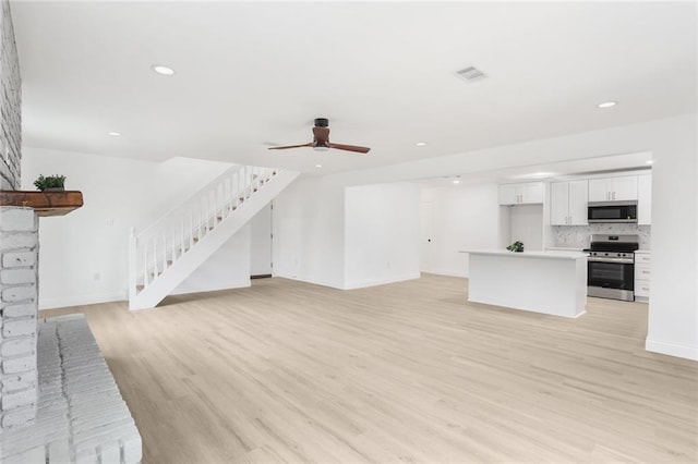 313 Post Dr, Luling, LA 70070 - unfurnished living room featuring stairway, light wood finished floors, recessed lighting, and ceiling fan