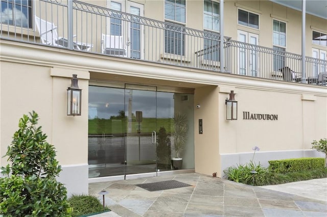 111 Audubon St Unit 202, New Orleans, LA 70118 - property entrance featuring stucco siding and a balcony