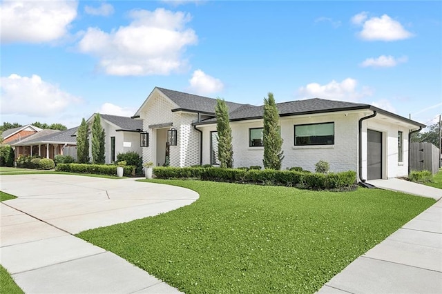 4548 Alphonse Dr, Metairie, LA 70006 - view of front facade featuring a garage, driveway, and a front yard