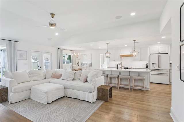 4548 Alphonse Dr, Metairie, LA 70006 - living room featuring a chandelier, recessed lighting, a ceiling fan, lofted ceiling, and light wood-style floors