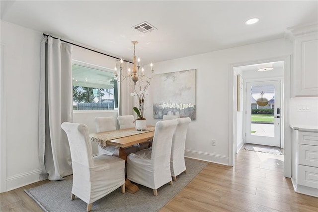 4548 Alphonse Dr, Metairie, LA 70006 - dining space with a chandelier and light wood-style flooring