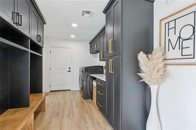 4548 Alphonse Dr, Metairie, LA 70006 - laundry area with washing machine and dryer, light wood-style flooring, recessed lighting, and cabinet space