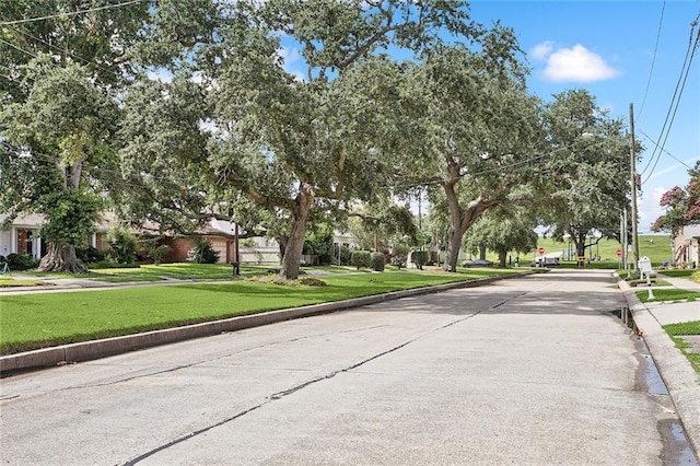 4548 Alphonse Dr, Metairie, LA 70006 - view of concrete road with curbs, traffic signs, and sidewalks