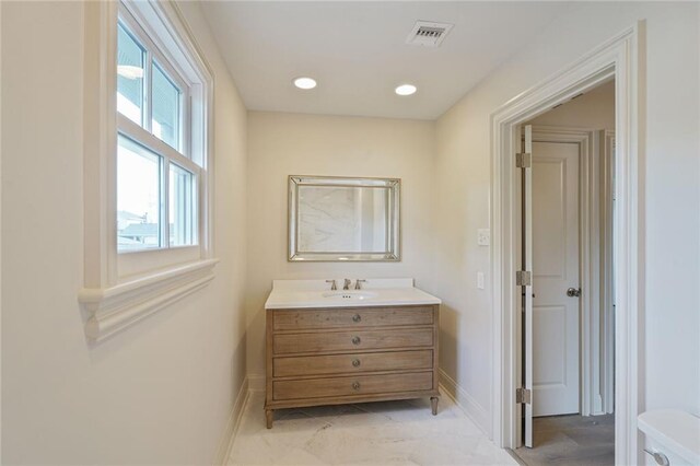 2232 N Starrett Rd, Metairie, LA 70003 - bathroom with vanity, recessed lighting, and marble finish flooring