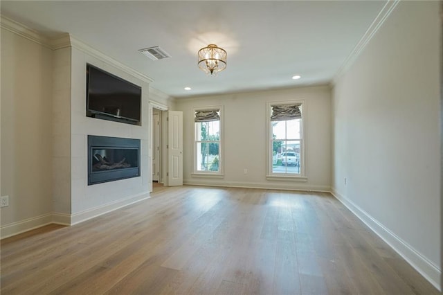 2232 N Starrett Rd, Metairie, LA 70003 - unfurnished living room with ornamental molding, wood finished floors, a fireplace, a chandelier, and recessed lighting
