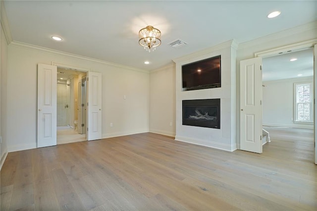 2232 N Starrett Rd, Metairie, LA 70003 - unfurnished living room featuring a large fireplace, wood finished floors, crown molding, a chandelier, and recessed lighting