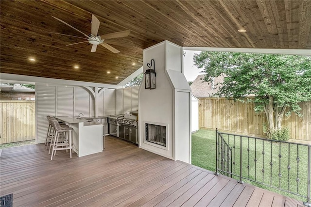 2232 N Starrett Rd, Metairie, LA 70003 - wooden deck featuring a fenced backyard, an outdoor kitchen, and ceiling fan