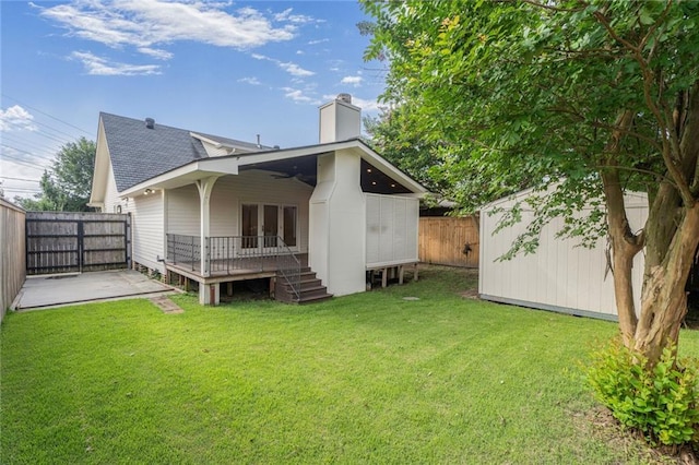2232 N Starrett Rd, Metairie, LA 70003 - rear view of property featuring a fenced backyard, a chimney, a deck, a ceiling fan, and roof with shingles