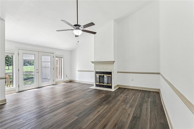 32 S Court Villa Dr Unit 32, Mandeville, LA 70471 - unfurnished living room featuring wood finished floors, lofted ceiling, a tile fireplace, a ceiling fan, and french doors