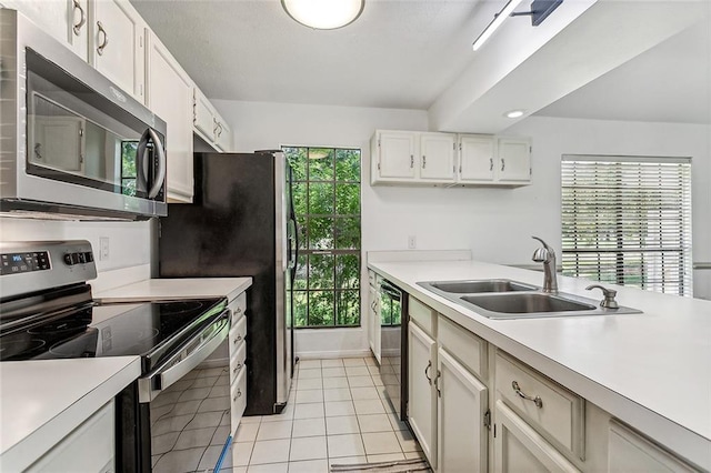 32 S Court Villa Dr Unit 32, Mandeville, LA 70471 - kitchen with stainless steel appliances, light countertops, healthy amount of natural light, and white cabinets