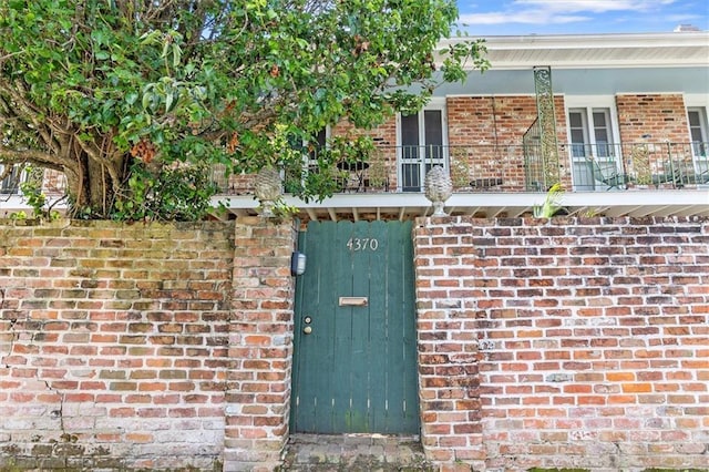 4370 Lasalle St -, Unit New Orleans, LA 70115 - doorway to property featuring brick siding and a balcony