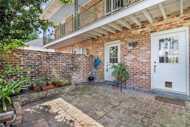 4370 Lasalle St -, Unit New Orleans, LA 70115 - doorway to property with a balcony, brick siding, and a patio