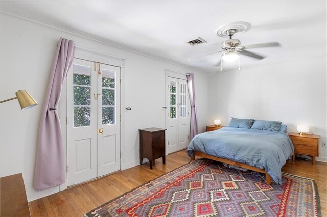 4370 Lasalle St -, Unit New Orleans, LA 70115 - bedroom with wood finished floors, a ceiling fan, and ornamental molding