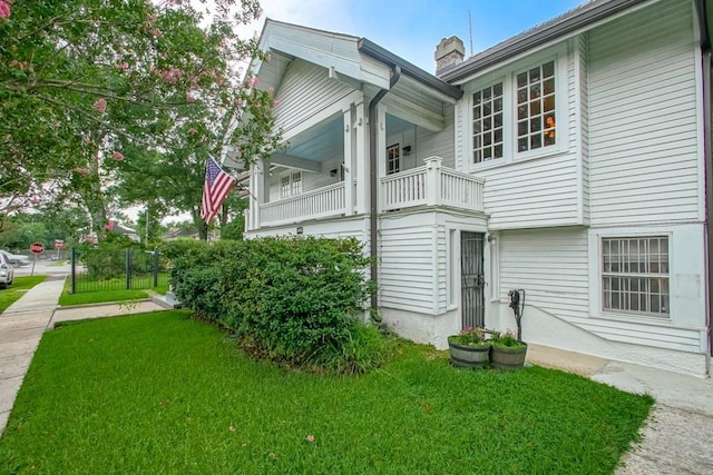 2410 Adams St, New Orleans, LA 70125 - view of side of property with a balcony and a lawn
