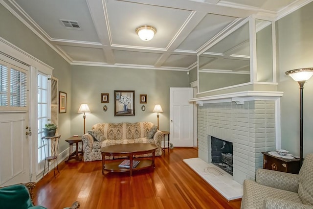 2410 Adams St, New Orleans, LA 70125 - living area featuring coffered ceiling, wood finished floors, a brick fireplace, and beamed ceiling