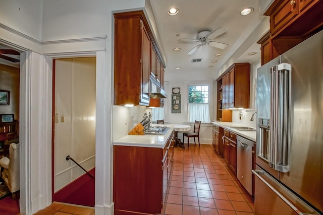 2410 Adams St, New Orleans, LA 70125 - kitchen featuring appliances with stainless steel finishes, ceiling fan, under cabinet range hood, light countertops, and recessed lighting