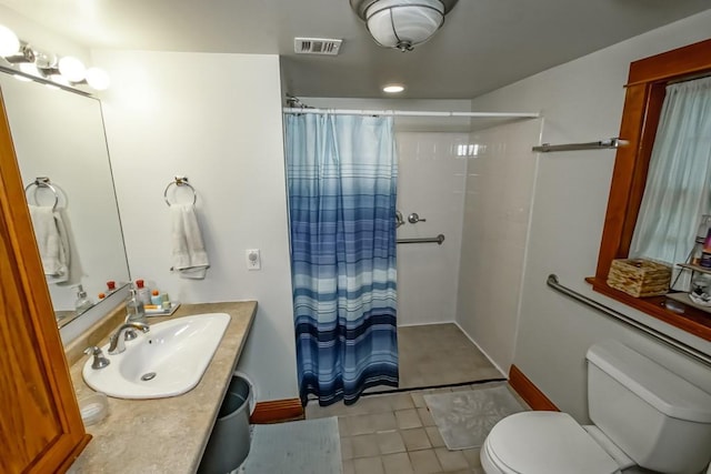 2410 Adams St, New Orleans, LA 70125 - bathroom featuring a shower with shower curtain, tile patterned flooring, and vanity