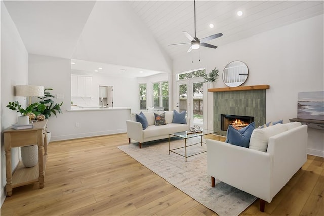 773 Rue Calais, Mandeville, LA 70471 - living room featuring a tile fireplace, ceiling fan, light wood finished floors, recessed lighting, and high vaulted ceiling