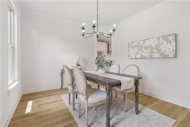773 Rue Calais, Mandeville, LA 70471 - dining area with a chandelier, ornamental molding, and light wood-type flooring