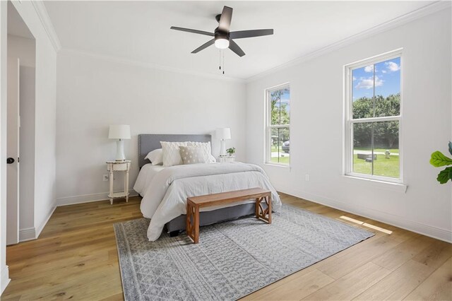 773 Rue Calais, Mandeville, LA 70471 - bedroom featuring crown molding, light wood-style floors, and ceiling fan