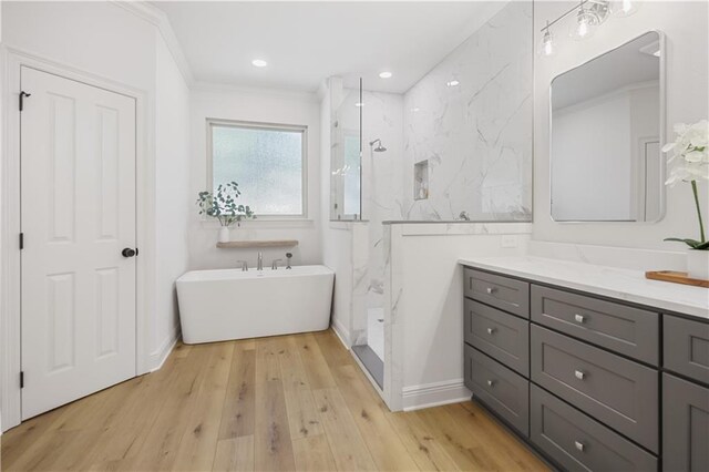 773 Rue Calais, Mandeville, LA 70471 - bathroom with a soaking tub, a marble finish shower, vanity, crown molding, and wood finished floors