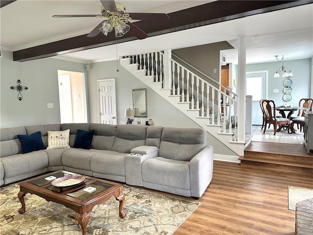 4908 David Dr, Kenner, LA 70065 - living area with stairway, wood finished floors, ornamental molding, and ceiling fan