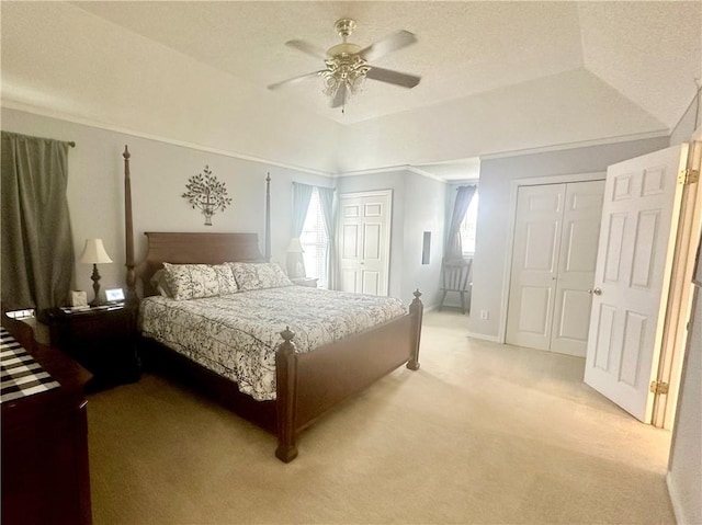 4908 David Dr, Kenner, LA 70065 - bedroom with light carpet, two closets, a tray ceiling, and ceiling fan