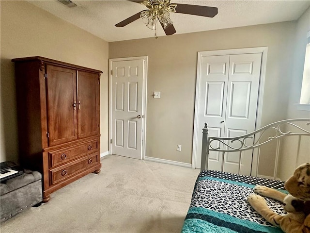 4908 David Dr, Kenner, LA 70065 - bedroom featuring light carpet, a ceiling fan, a closet, and a textured ceiling