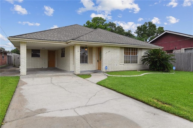 4520 Fairfield St, Metairie, LA 70006 - view of front of property featuring brick siding, driveway, an attached carport, and roof with shingles