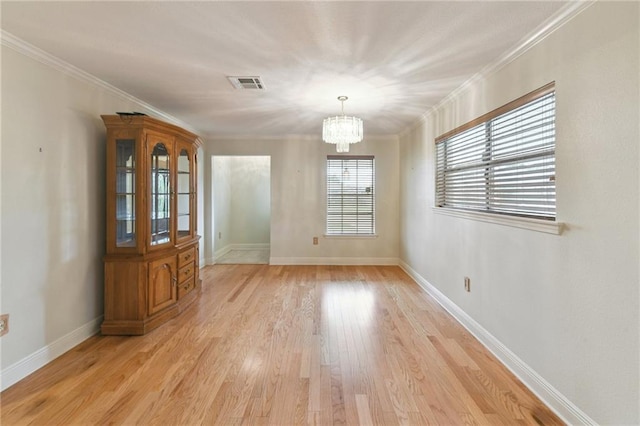 4520 Fairfield St, Metairie, LA 70006 - unfurnished dining area with a chandelier, light wood-style flooring, and ornamental molding