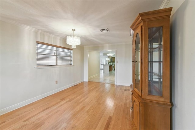4520 Fairfield St, Metairie, LA 70006 - unfurnished dining area featuring a chandelier, ornamental molding, and light wood finished floors