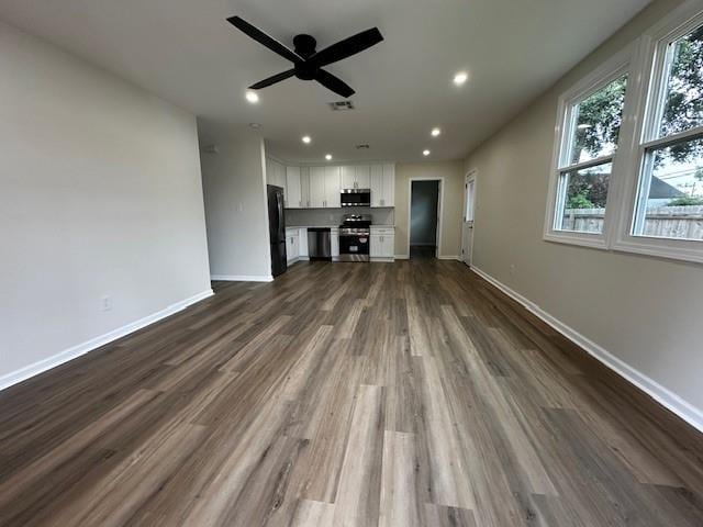 1018 Marian Ave, Metairie, LA 70001 - unfurnished living room featuring ceiling fan, dark wood-type flooring, and recessed lighting