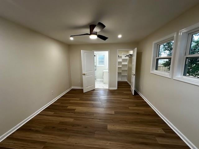 1018 Marian Ave, Metairie, LA 70001 - unfurnished bedroom featuring a walk in closet, dark wood-style flooring, recessed lighting, ceiling fan, and ensuite bath