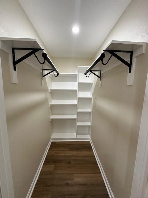 1018 Marian Ave, Metairie, LA 70001 - walk in closet with dark wood-style floors