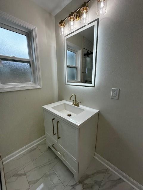 1018 Marian Ave, Metairie, LA 70001 - bathroom with marble look tile flooring and vanity