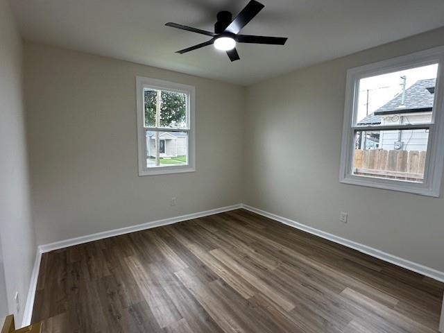 1018 Marian Ave, Metairie, LA 70001 - spare room with dark wood finished floors and a ceiling fan
