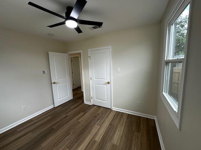 1018 Marian Ave, Metairie, LA 70001 - unfurnished bedroom featuring dark wood finished floors and a ceiling fan