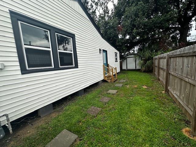 1018 Marian Ave, Metairie, LA 70001 - view of yard with entry steps and a storage shed