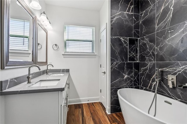 301113 Wall Blvd, New Orleans, LA 70114 - full bathroom featuring double vanity, a soaking tub, and wood finished floors