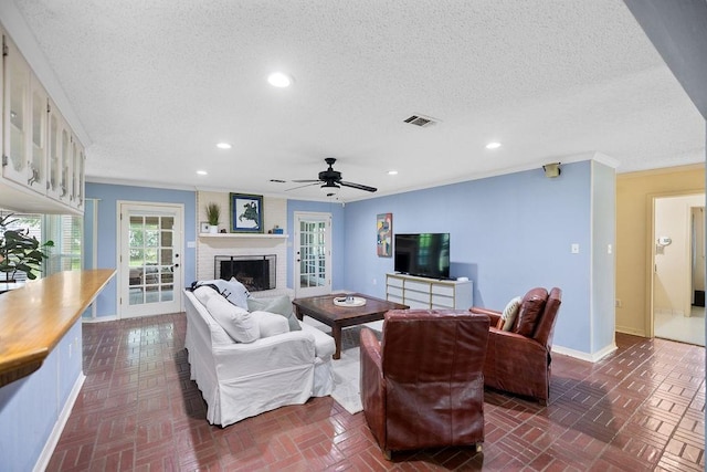 708 W Colorado Ave, Hammond, LA 70401 - living area featuring recessed lighting, a brick fireplace, a textured ceiling, ornamental molding, and ceiling fan