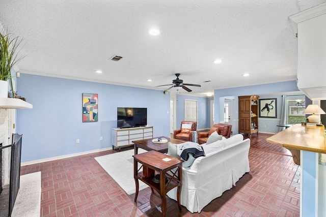 708 W Colorado Ave, Hammond, LA 70401 - living room featuring brick patterned flooring, a ceiling fan, recessed lighting, a fireplace, and a textured ceiling