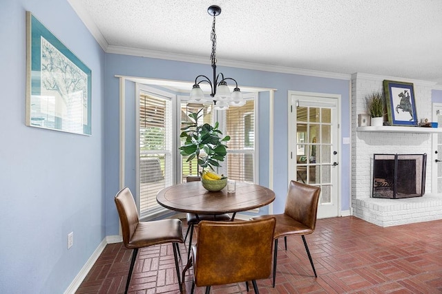 708 W Colorado Ave, Hammond, LA 70401 - dining area featuring brick floors, a chandelier, a textured ceiling, a fireplace, and ornamental molding