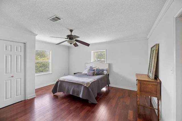 708 W Colorado Ave, Hammond, LA 70401 - bedroom featuring multiple windows, hardwood / wood-style flooring, ornamental molding, a textured ceiling, and a ceiling fan